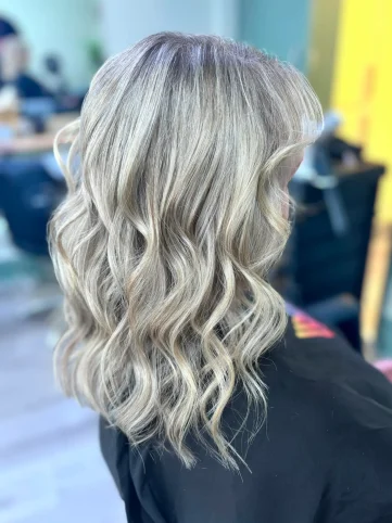 Blonde balayage highlights with soft waves styled at our hair salon in Huntington York