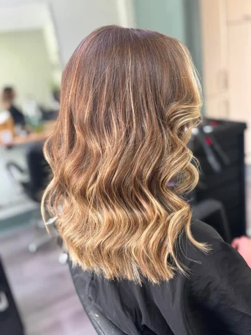 Brunette balayage with caramel and golden highlights on long wavy hair - hair salon Huntington York